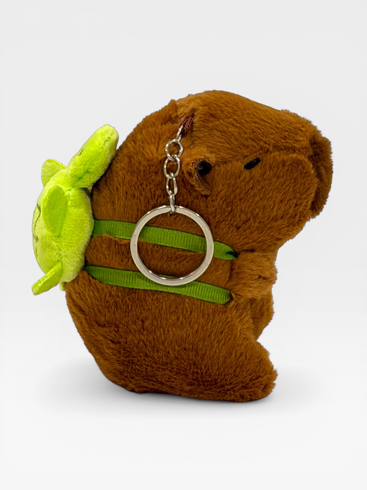 Plush toy Capybara with a green fturtle