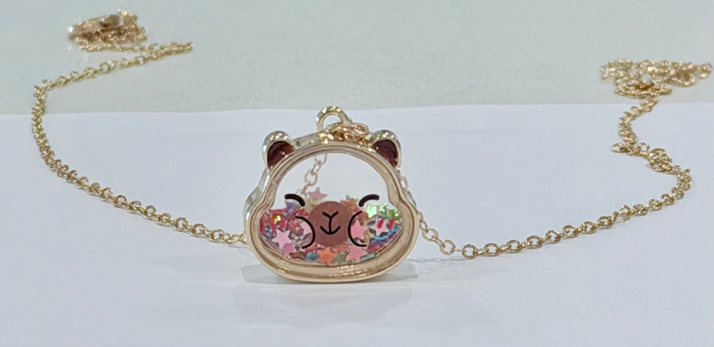 Necklace with a capybara-shaped pendant on a white background