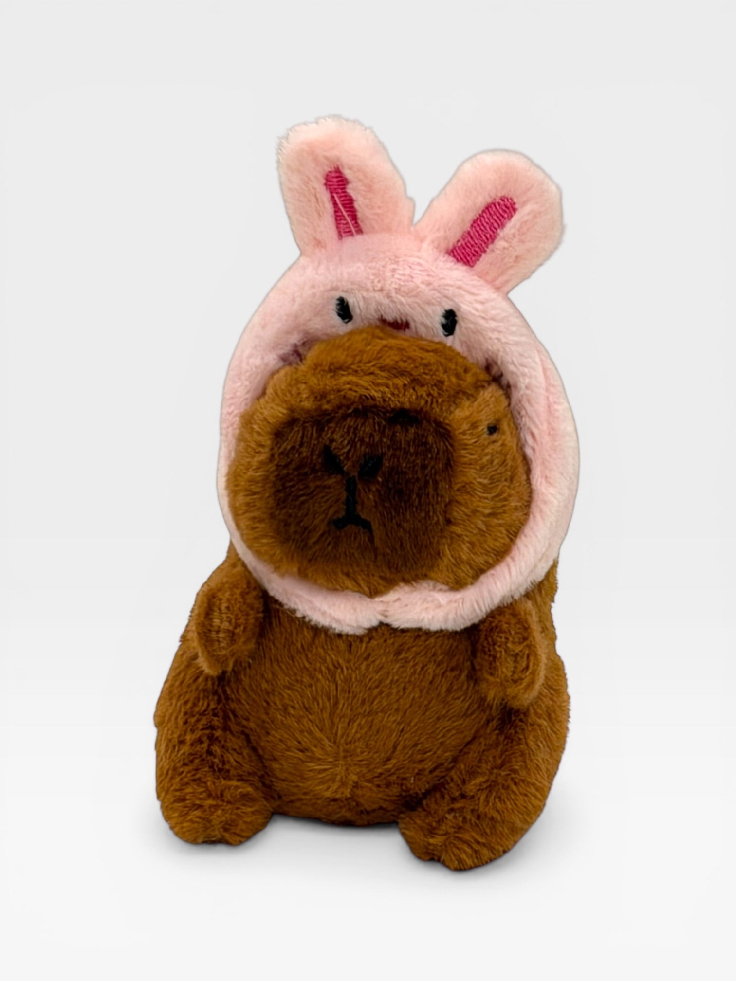 Plush toy with a brown body and pink bunny ears