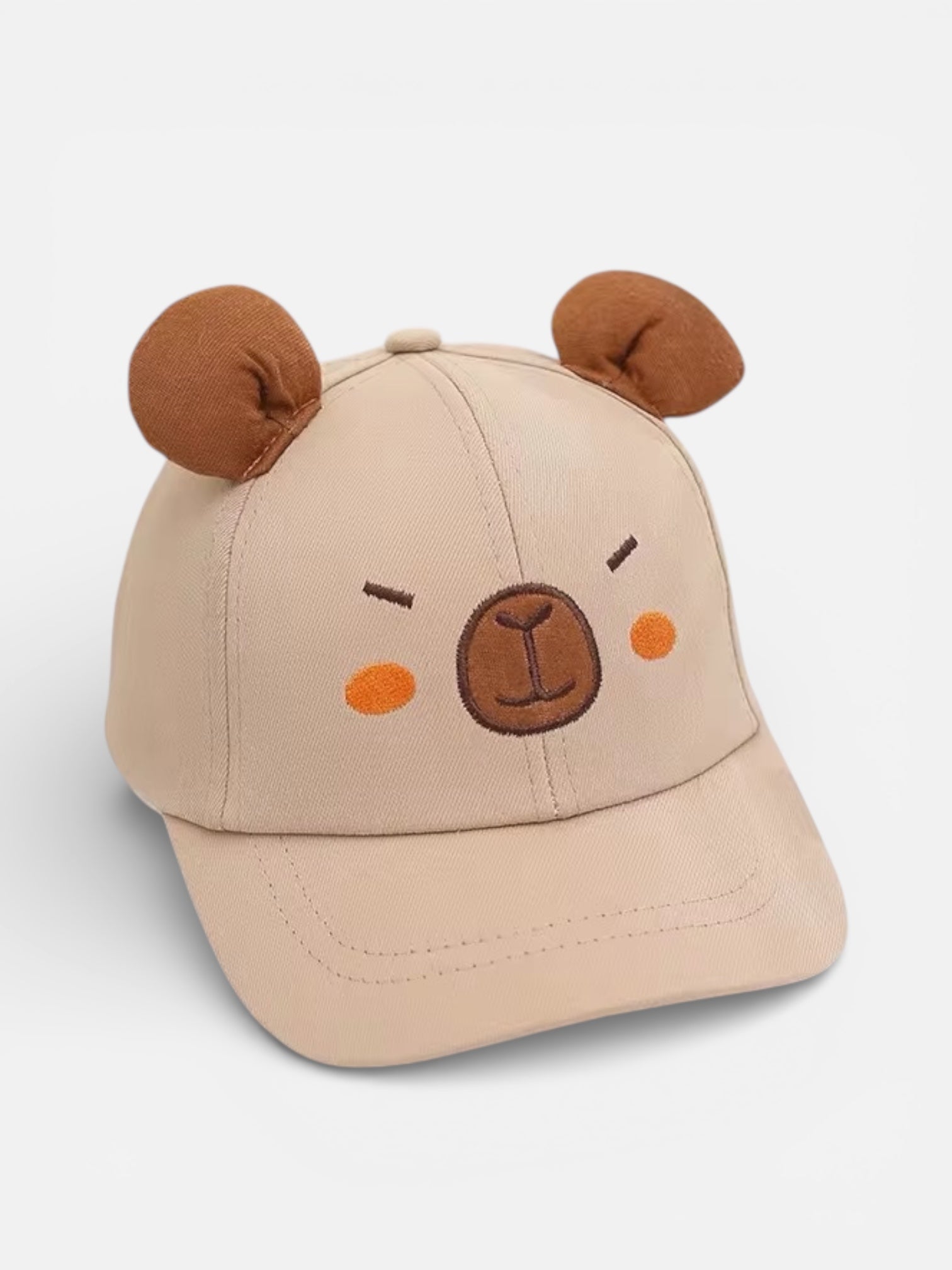 Beige cap with bear ears and face on a light gray background