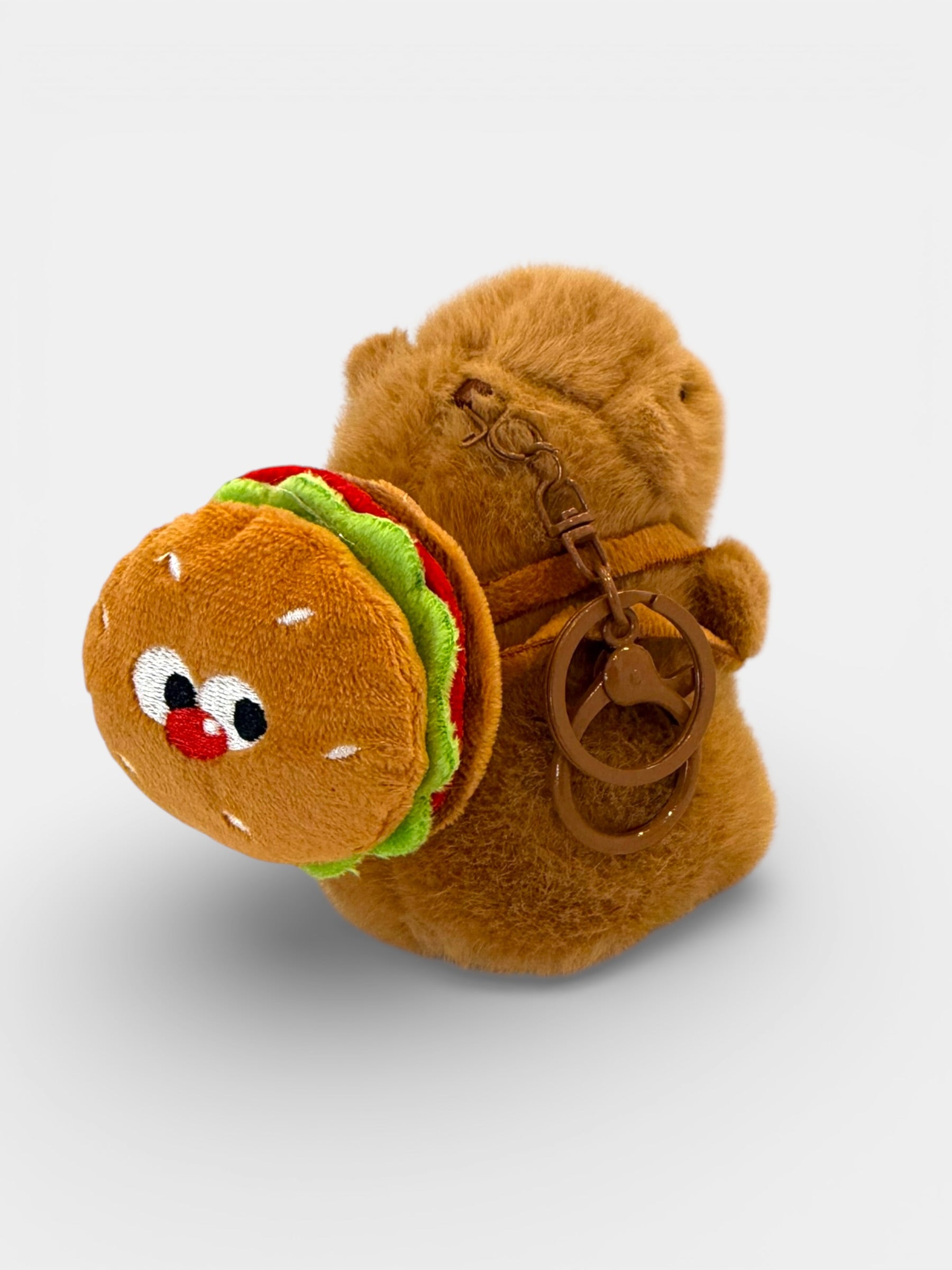 Plush toy bear with a hamburger attached, on a white background