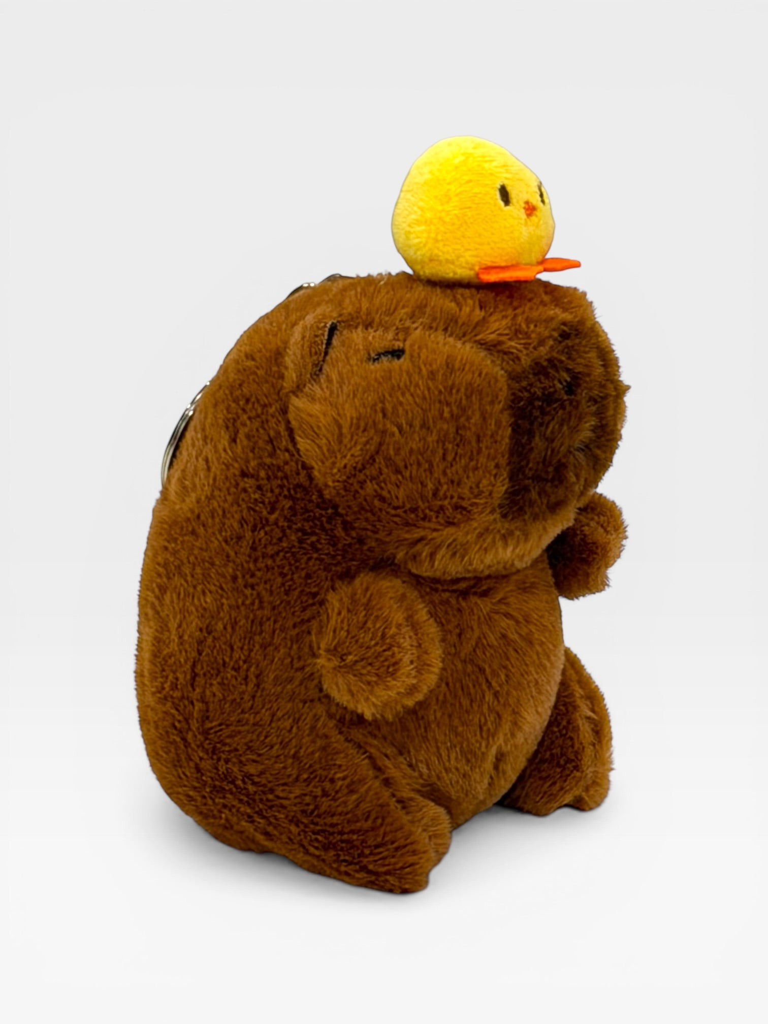 Plush Capybara toy with a yellow duck on its head