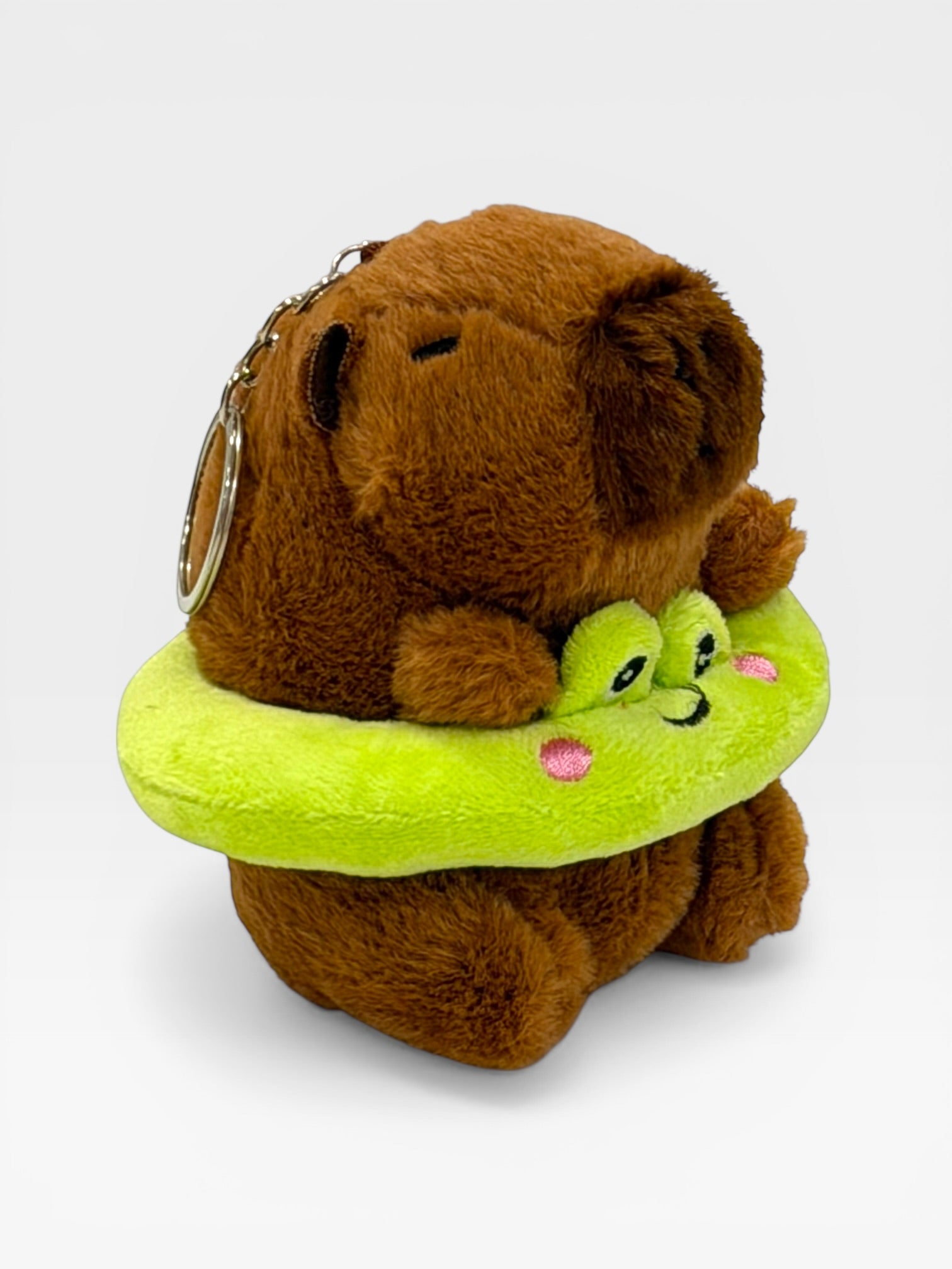 Plush toy keychain with Capybara and green creature on a white background
