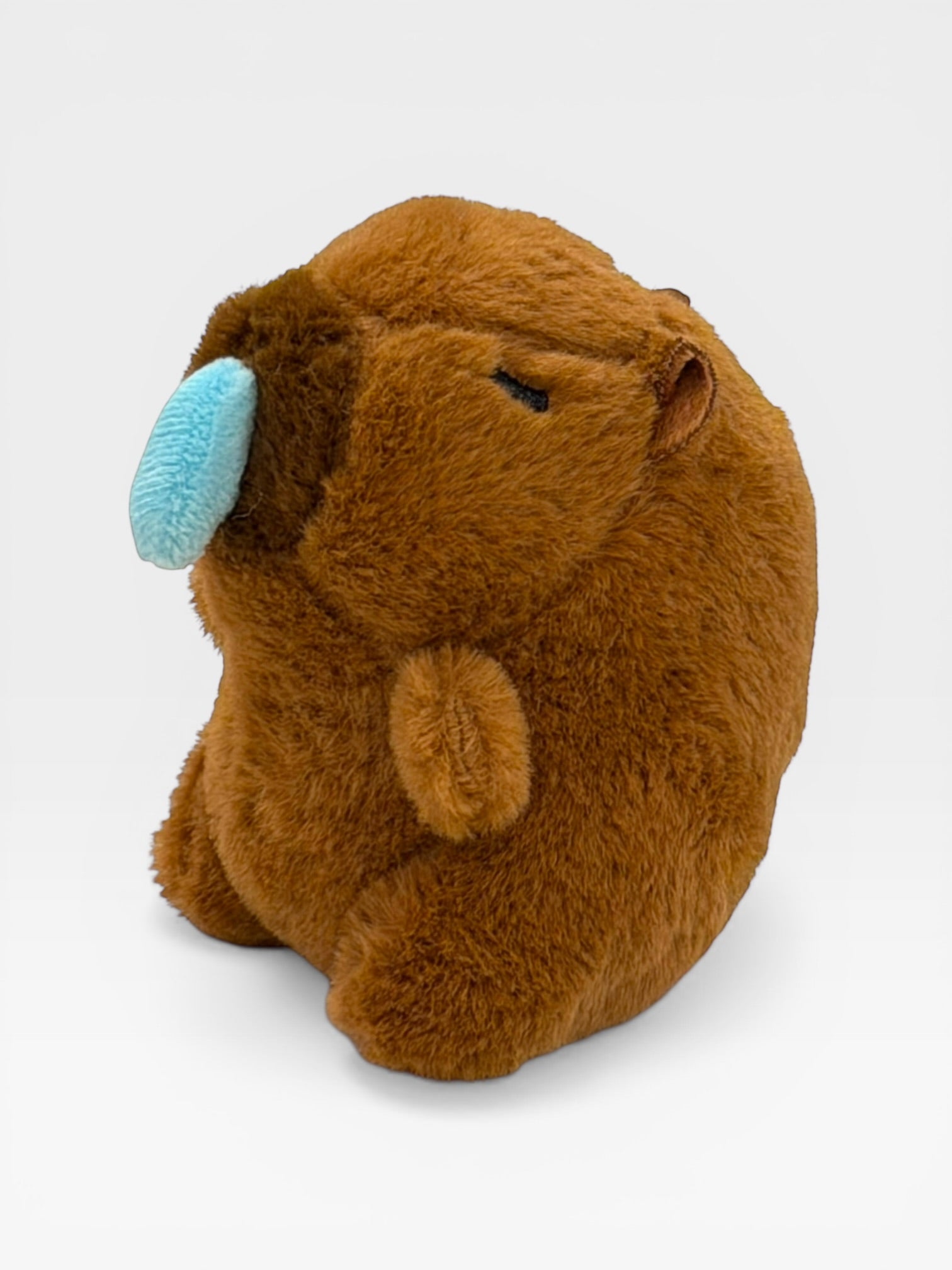 Plush toy resembling a Capybara with a blue nose 