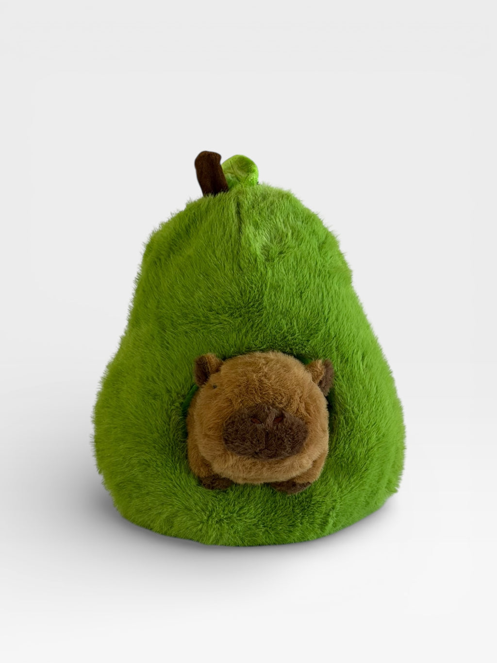 Green plush pear-shaped toy with a Capybara on a white background