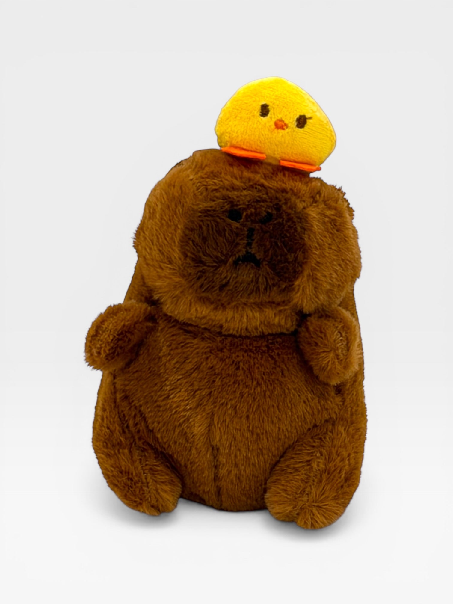 Plush Capybara with a small yellow chick on its back 