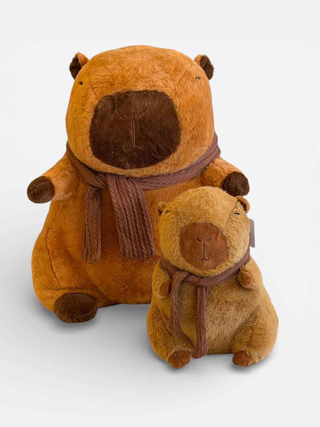Two brown plush animal Capybara with scarves 